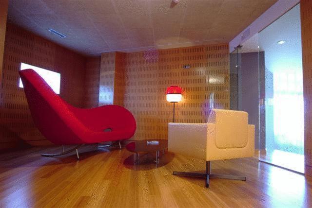 a living room with a couch, chair and a lamp at Colón Tuy in Tui