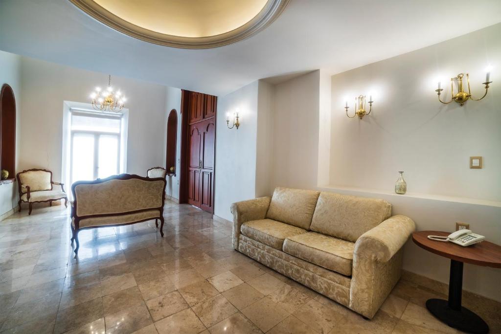 a living room with a couch and a table at Hotel Imperial in Veracruz