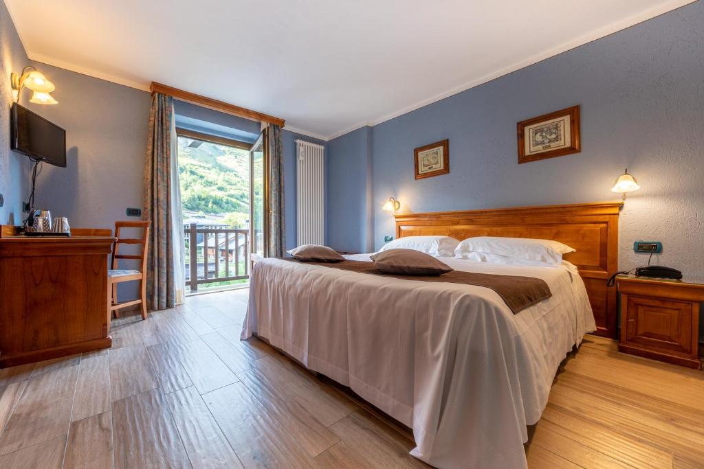Postel nebo postele na pokoji v ubytování Hotel Du Glacier