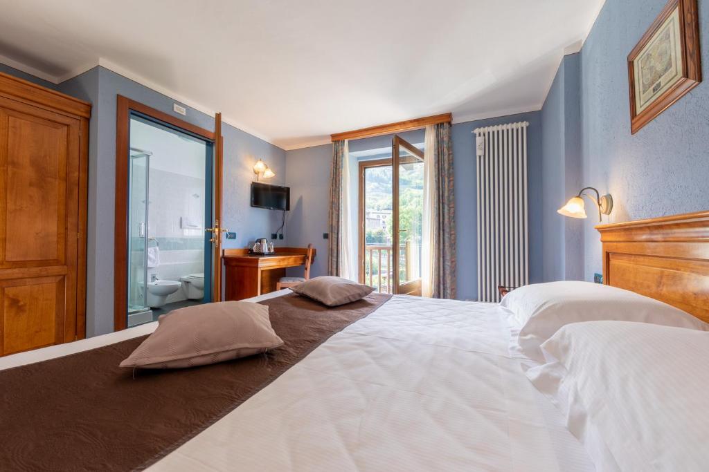 Postel nebo postele na pokoji v ubytování Hotel Du Glacier