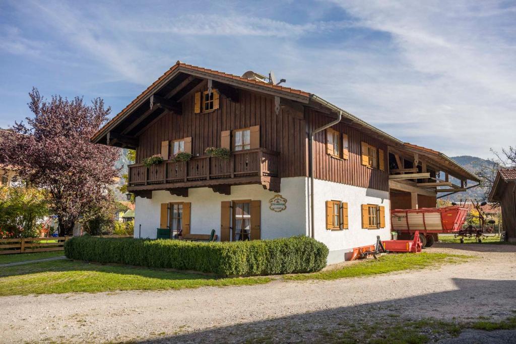 a large wooden house with a balcony on top at Christophenhof in Oberaudorf