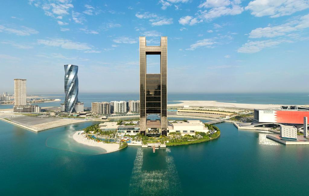 an aerial view of a city with buildings and water at Four Seasons Hotel Bahrain Bay in Manama