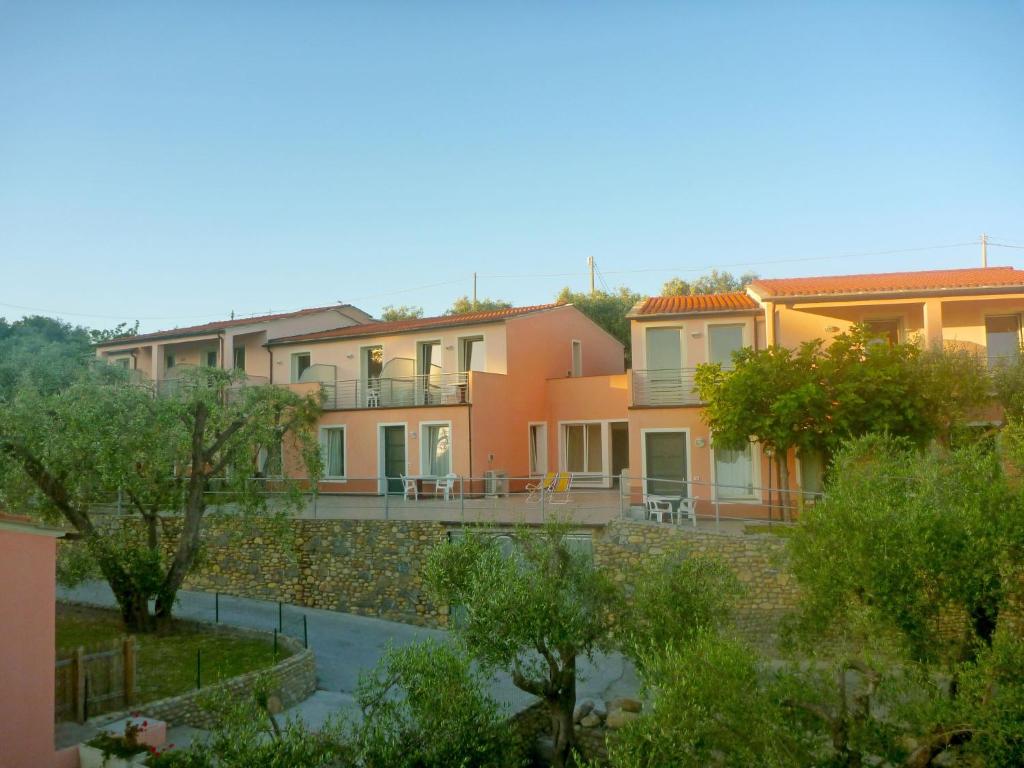 a row of houses with trees in front of them at Apartment Borgoverde-3 by Interhome in Imperia