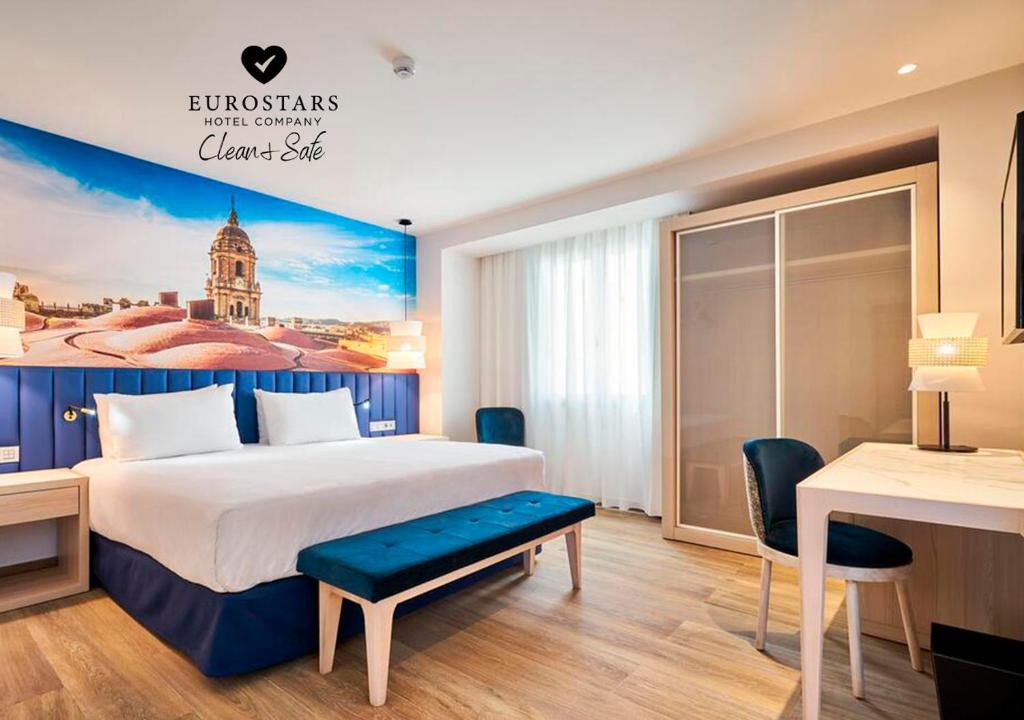 a hotel room with a bed and a desk at Eurostars Astoria in Málaga