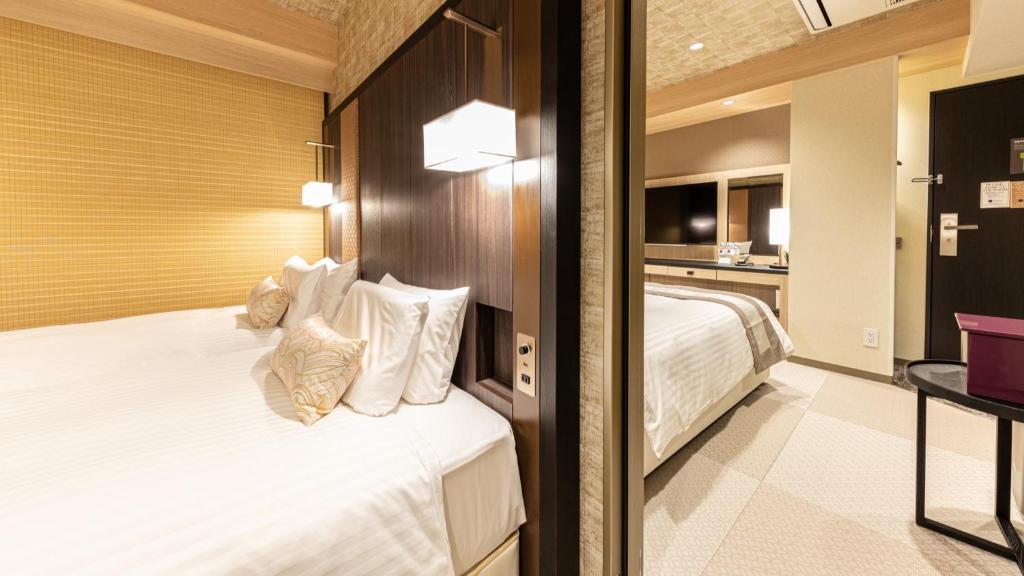 Postel nebo postele na pokoji v ubytování Hotel Musse Kyoto Shijo Kawaramachi Meitetsu