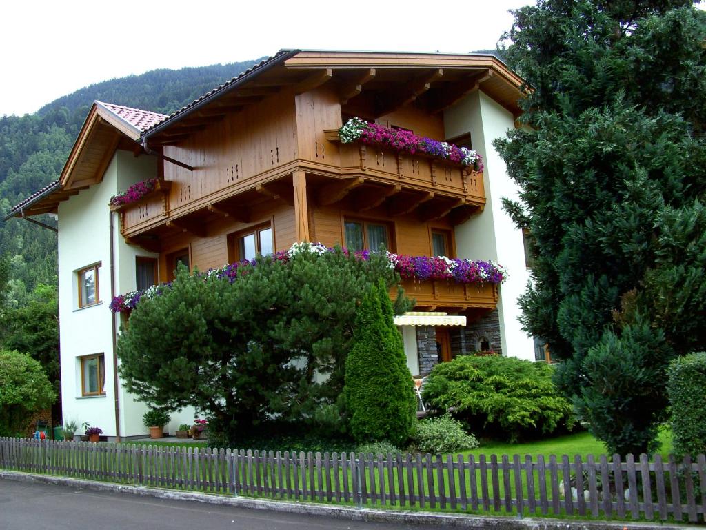 a house with a balcony with flowers on it at Haus Christl in Aschau