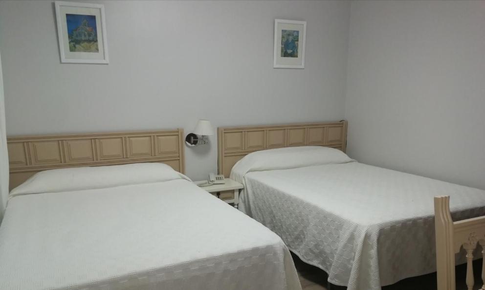 A bed or beds in a room at Hostal Antolín