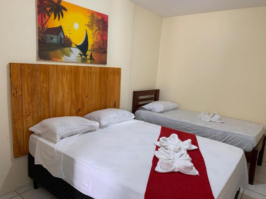 Ένα ή περισσότερα κρεβάτια σε δωμάτιο στο Okay Pousada praia de iracema