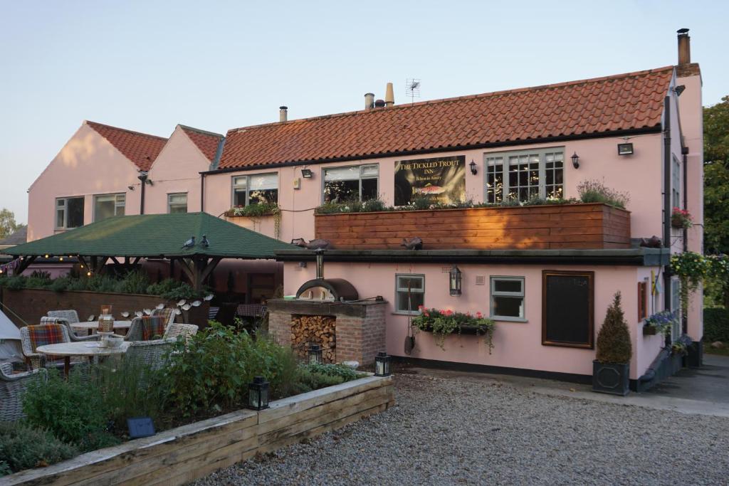 a pink house with a garden in front of it at The Tickled Trout Inn Bilton-in-Ainsty in York