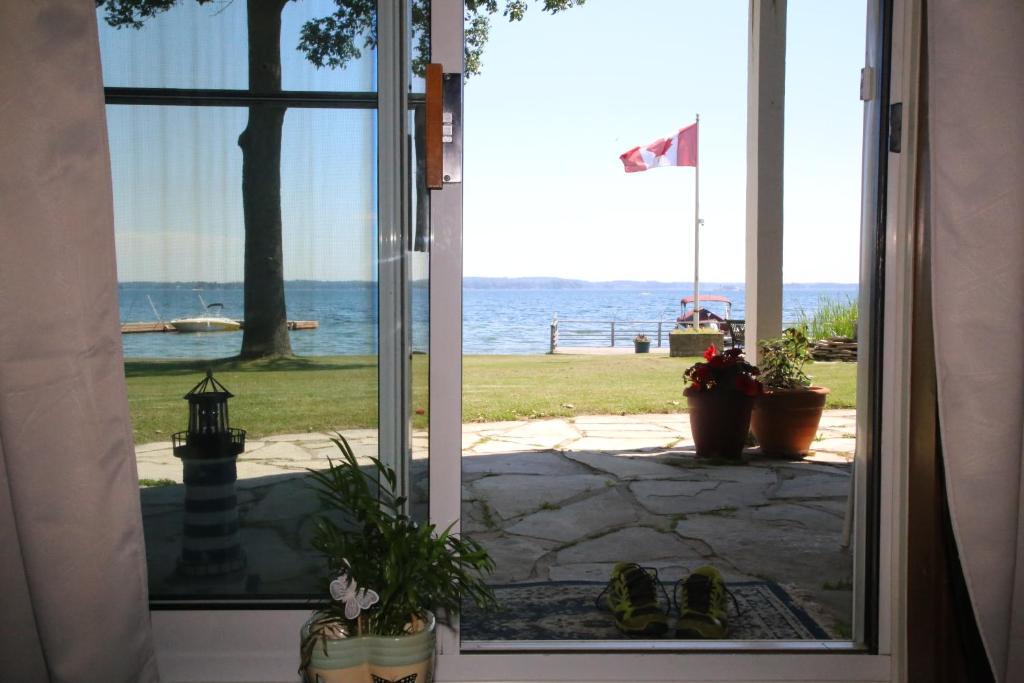 an open door with a view of the ocean at Home of Thousand Islands in Gananoque