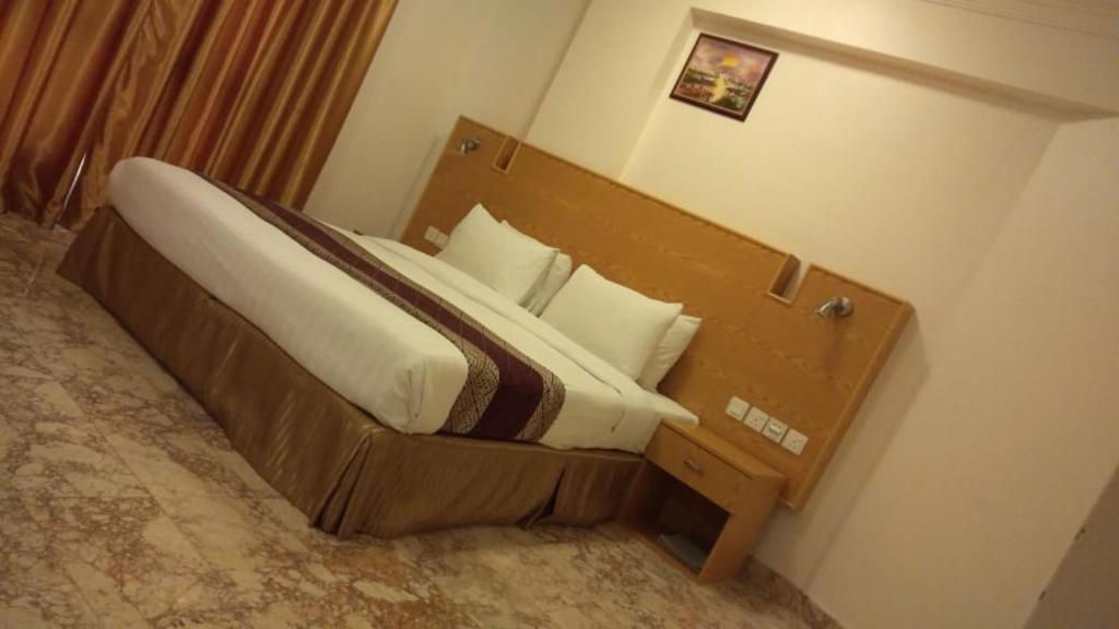 Postel nebo postele na pokoji v ubytování Al Reef Hotel