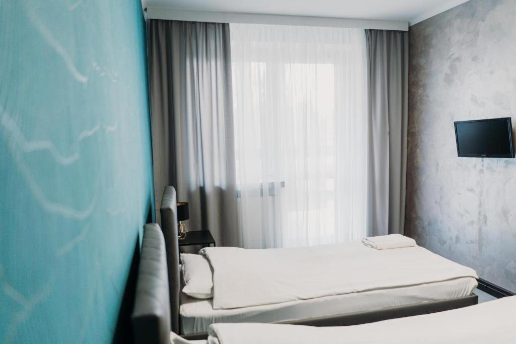 Postel nebo postele na pokoji v ubytování Hotel Kinga
