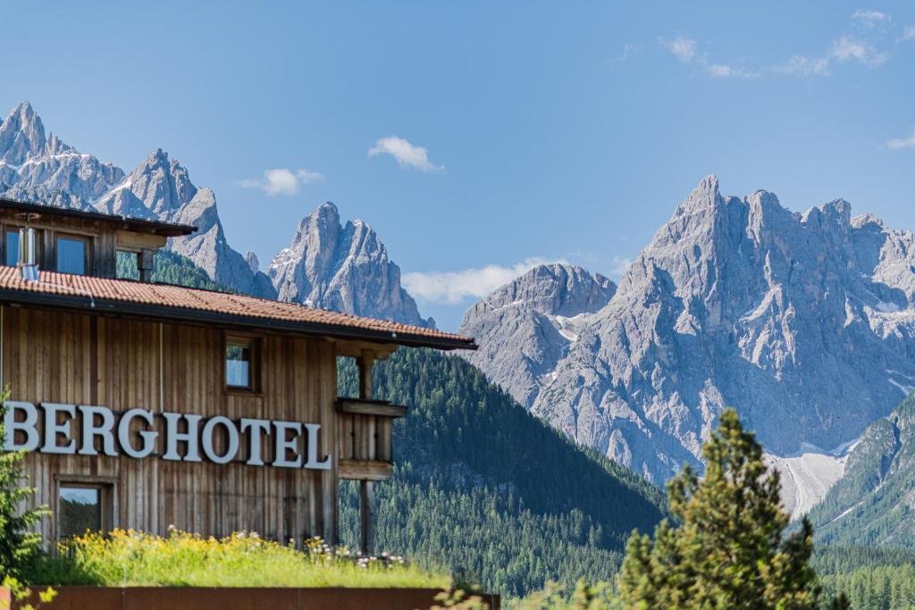 a hotel with the mountains in the background at Berghotel - Sexten in Sesto