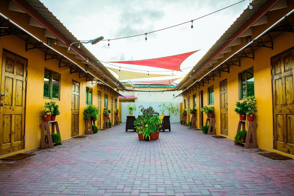 an empty courtyard of a building with potted plants at Aruba Smart Apartments in Palm-Eagle Beach