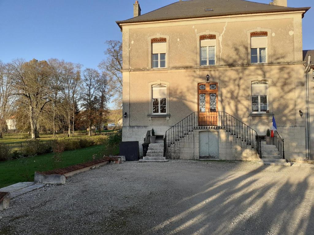 an old house with a staircase in front of it at La Maison Du Canal in Houdelaincourt