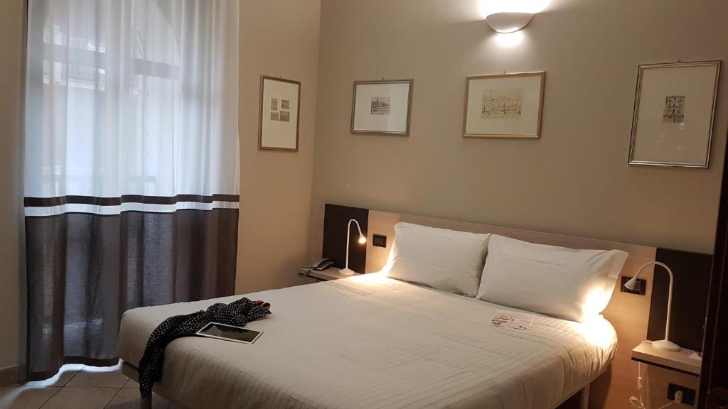 Postel nebo postele na pokoji v ubytování Hotel Gran Torino
