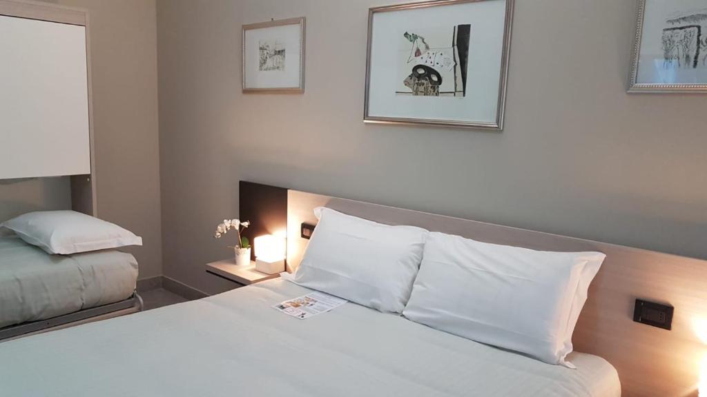Postel nebo postele na pokoji v ubytování Hotel Gran Torino