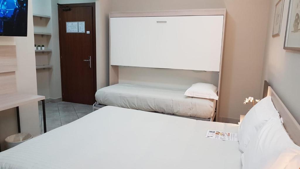 Postel nebo postele na pokoji v ubytování Hotel Gran Torino