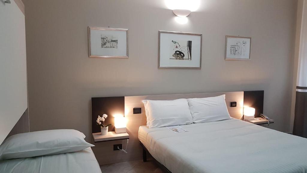 Postel nebo postele na pokoji v ubytování Hotel Gran Torino