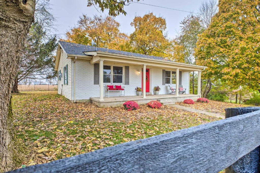 a small white house with a red door at Charming Guesthouse Getaway on 10-Acre Farm! in Harrodsburg