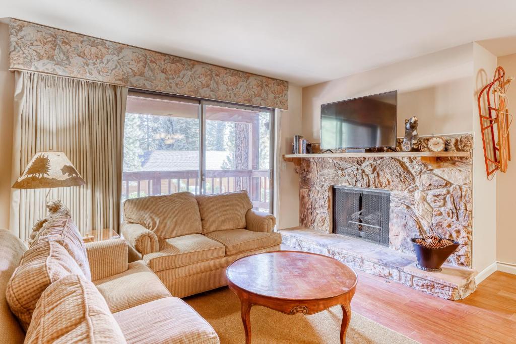 a living room with a couch and a fireplace at Incline Oasis in Incline Village