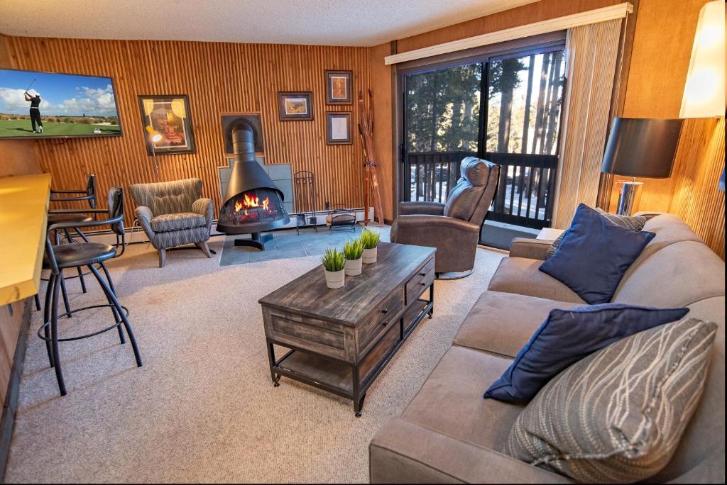 a living room with a couch and a fireplace at Peak 8 Village Getaway Condo: On Shuttle Route in Breckenridge