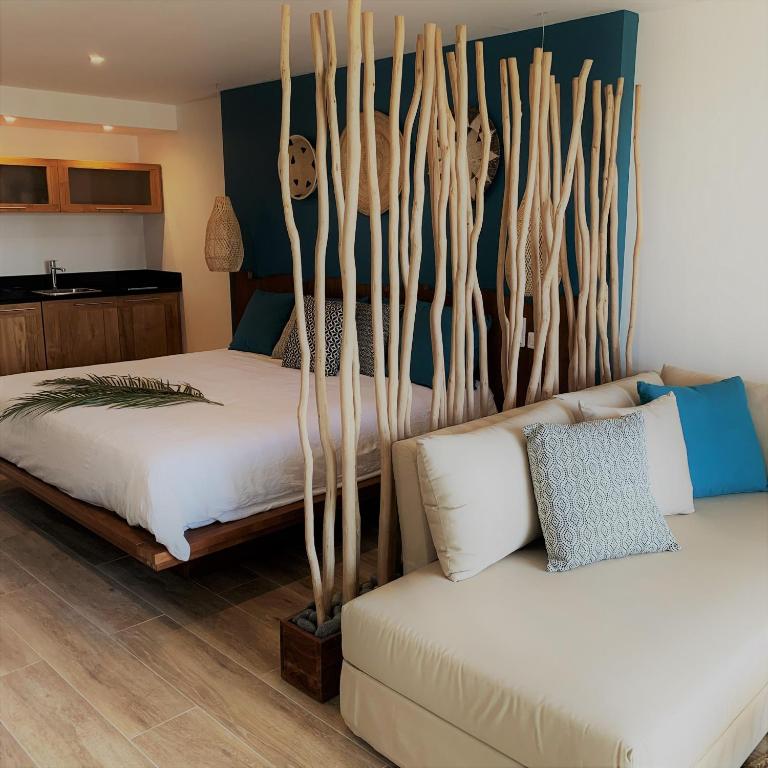 a bedroom with two beds and a couch at Orient Beach Hotel in Orient Bay