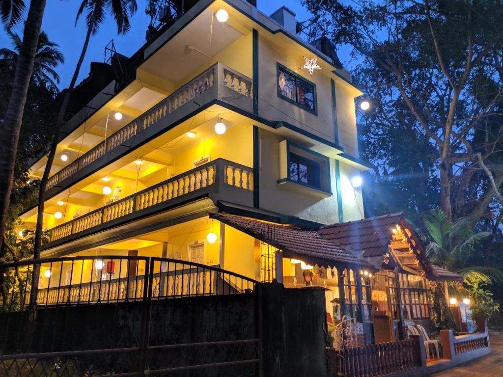 a large building with lights on it at night at Rustic Village - By Rivasa in Calangute