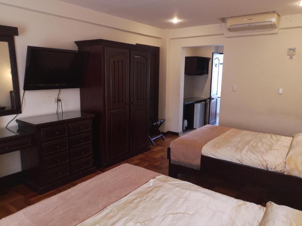 Postel nebo postele na pokoji v ubytování Hotel Plaza Real Suites & Apartments San Jose