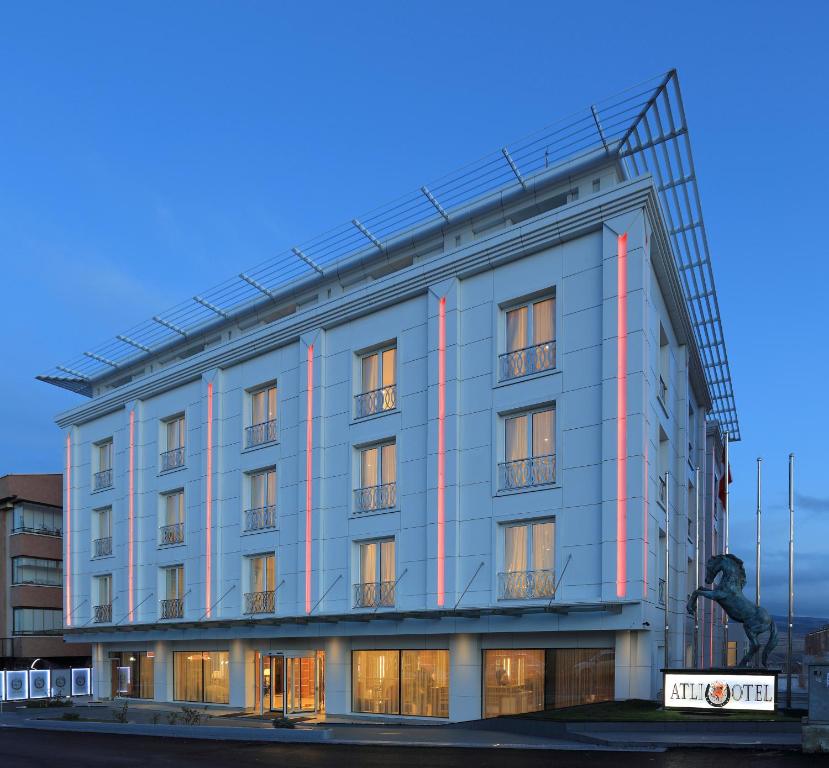 un grand bâtiment gris avec des bandes rouges dans l'établissement Atli Hotel Ankara, à Ankara