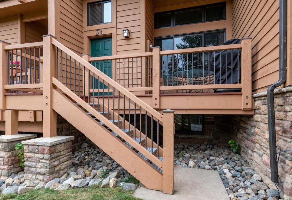 a house with a wooden staircase in front of it at Cedars 38 Townhome Ski In Ski Out in Breckenridge