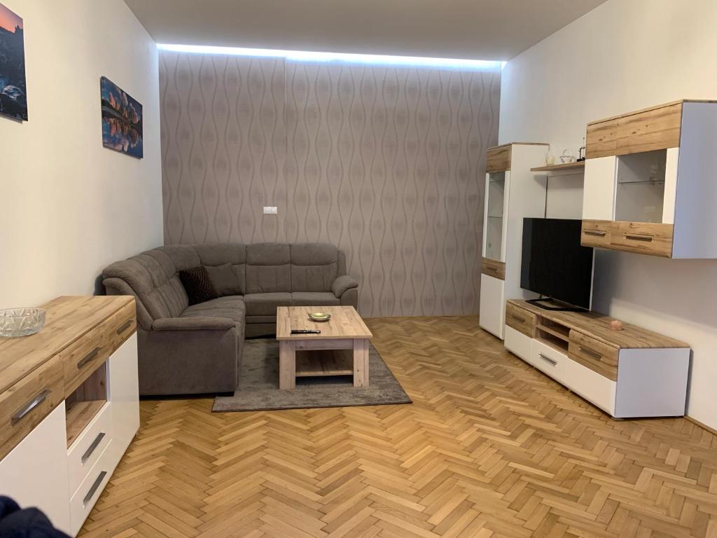 a living room with a couch and a table at Apartman Centrum 301 in Ústí nad Labem