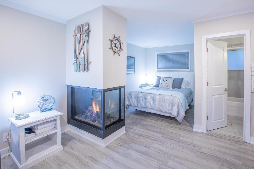 a bedroom with a fireplace next to a bed at Boutique Suite #2 in Blue Mountains