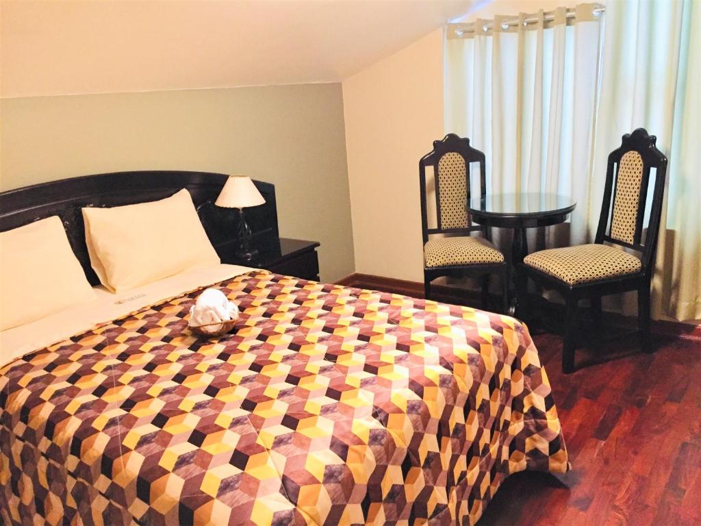 Postel nebo postele na pokoji v ubytování Hostal Carlos Tenaud