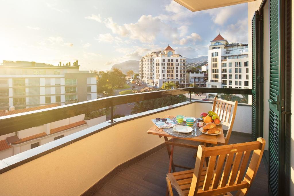 a balcony with a table with fruit on it at Golden Sea Horizon in Funchal