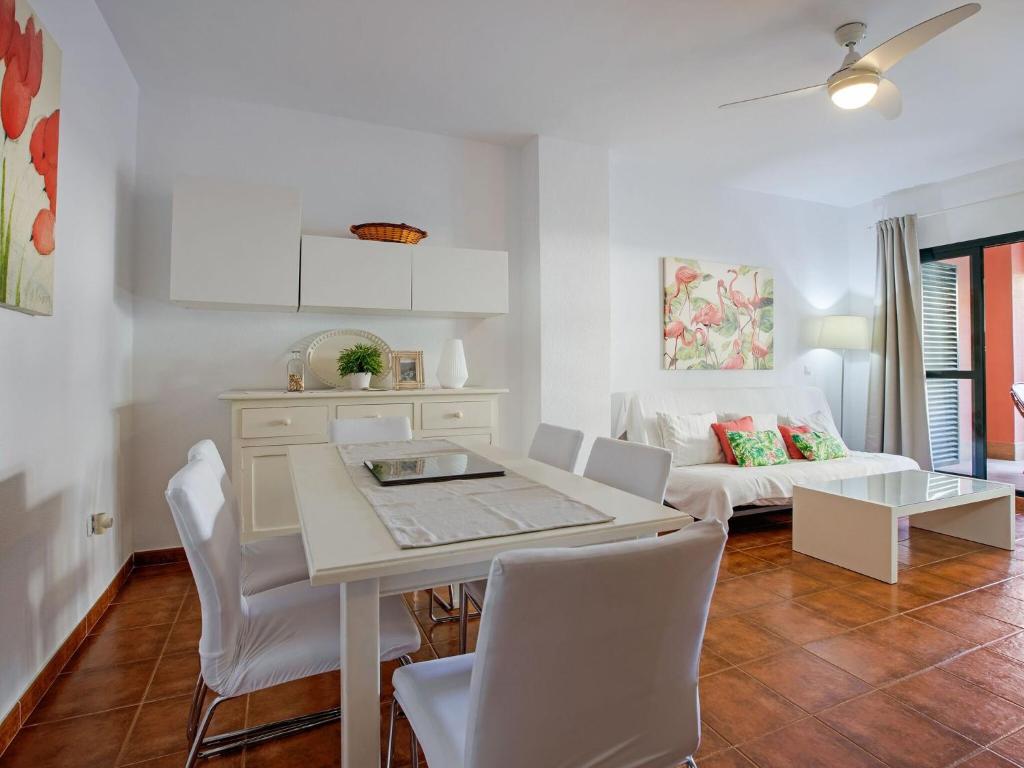 a living room with a table and chairs and a couch at Charming Apartment in Zahara de los Atunes near Beach in Zahara de los Atunes