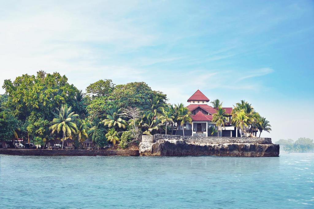 a house on a small island in the water at Patra Anyer in Anyer