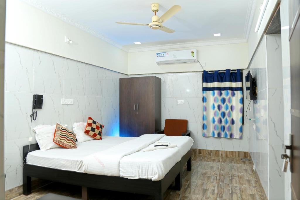 a hospital room with a bed and a ceiling fan at Lakeview Residency, Sricity TADA in Tada