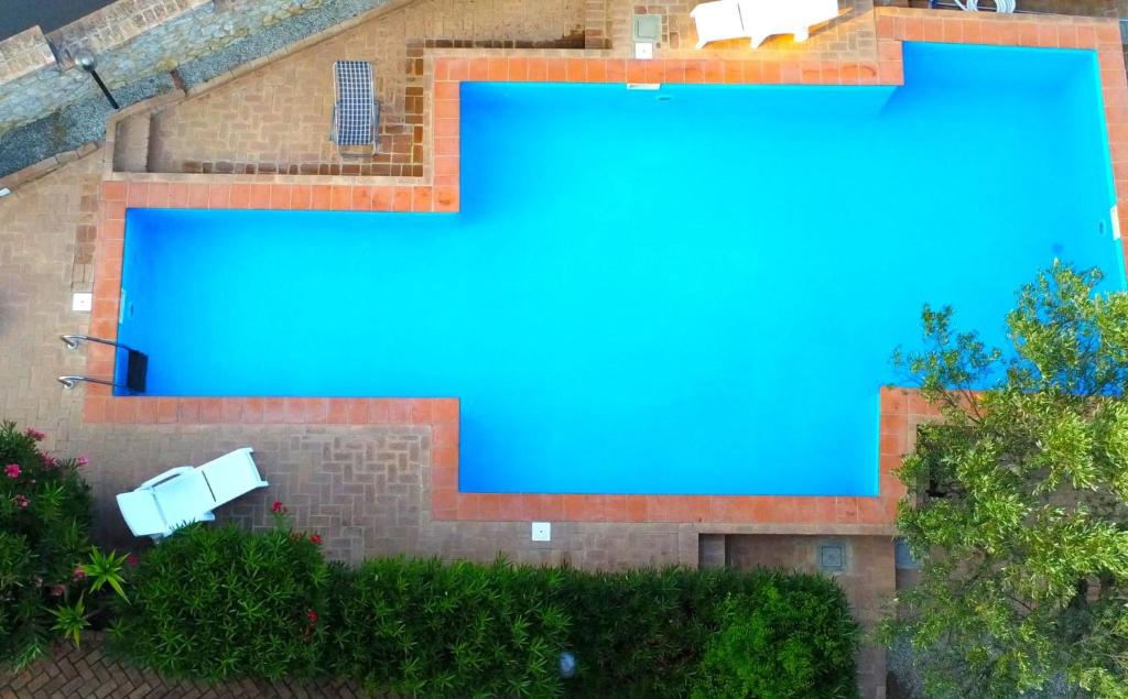 - une vue sur la piscine d'eau bleue dans l'établissement Residence Cassiodoro, à Stalettì
