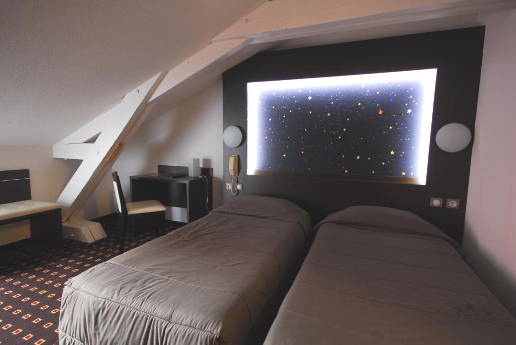 Postel nebo postele na pokoji v ubytování Hôtel Stella