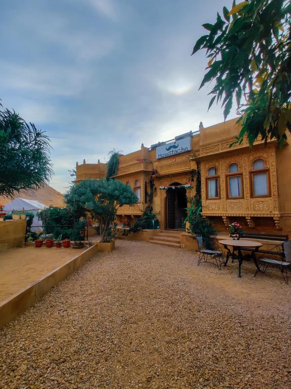 um grande edifício com uma mesa em frente em Moustache Jaisalmer em Jaisalmer