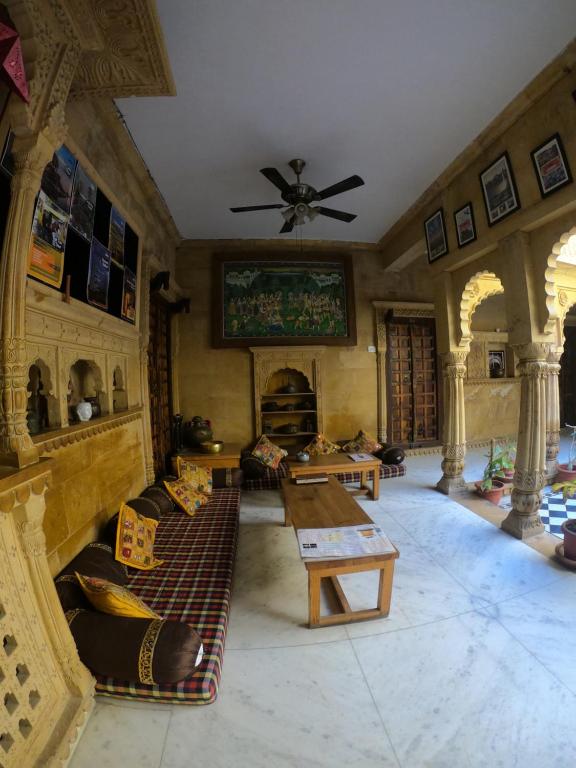 a living room with couches and a ceiling fan at Moustache Jaisalmer in Jaisalmer