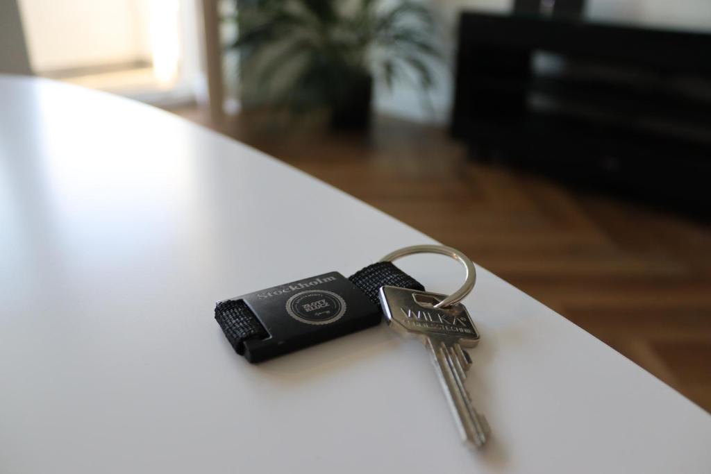 a pair of keys sitting on top of a table at Apartamenty Asapartment Stockholm in Olsztyn
