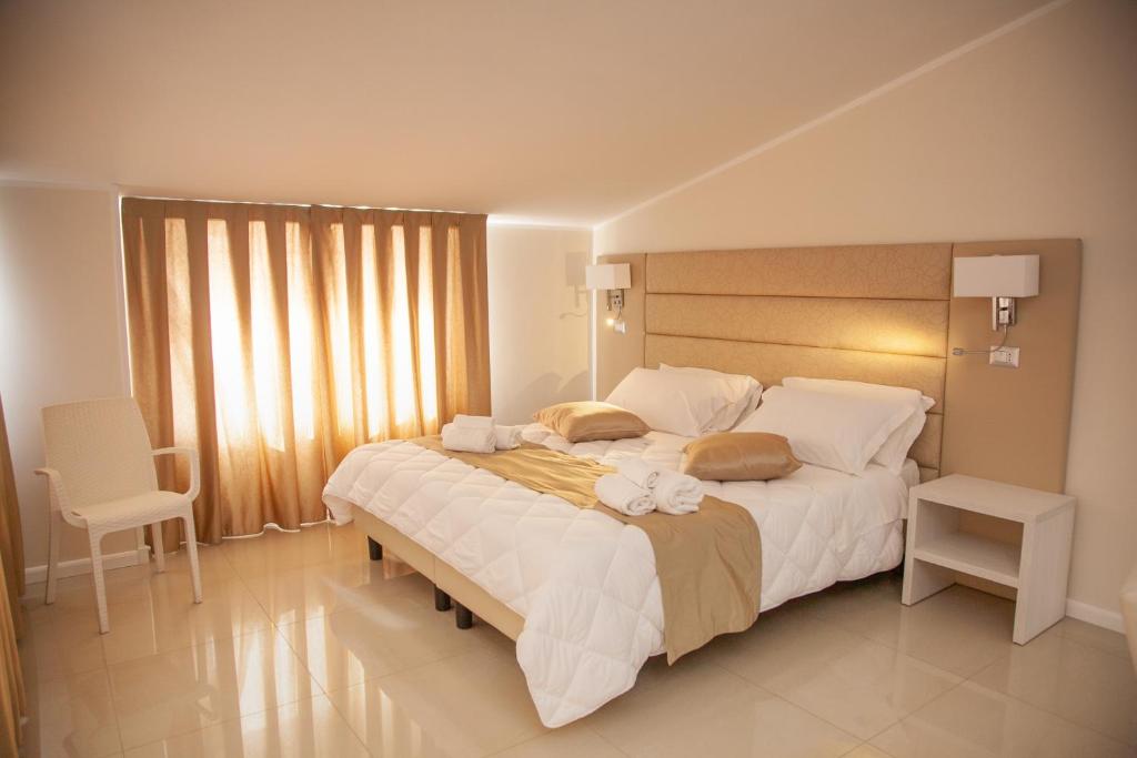 Postel nebo postele na pokoji v ubytování Hotel Dolce Stella