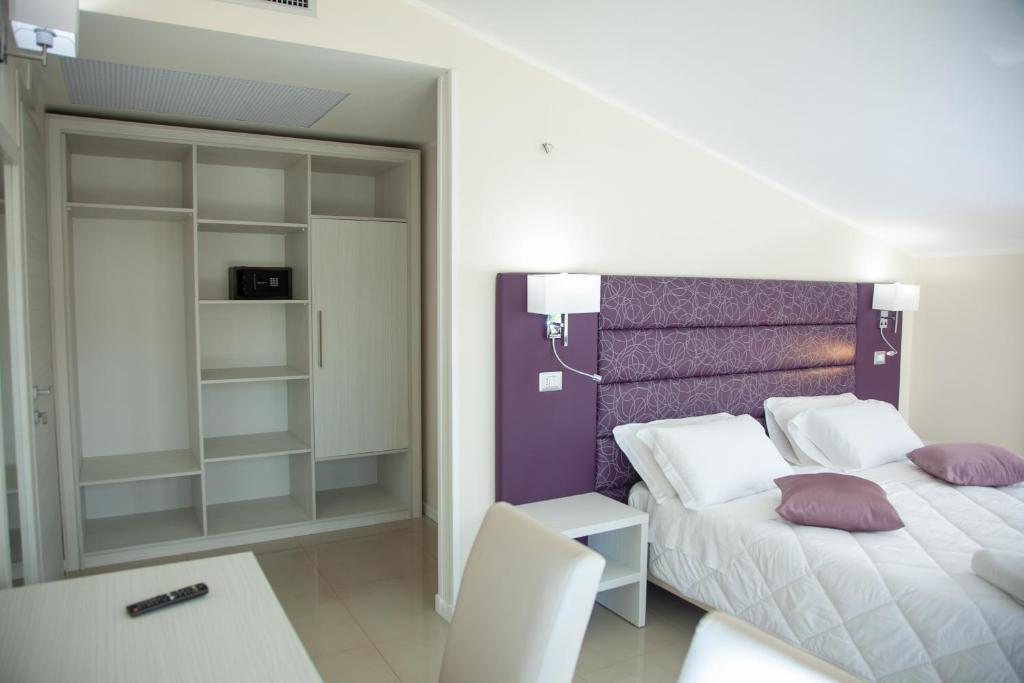 Postel nebo postele na pokoji v ubytování Hotel Dolce Stella