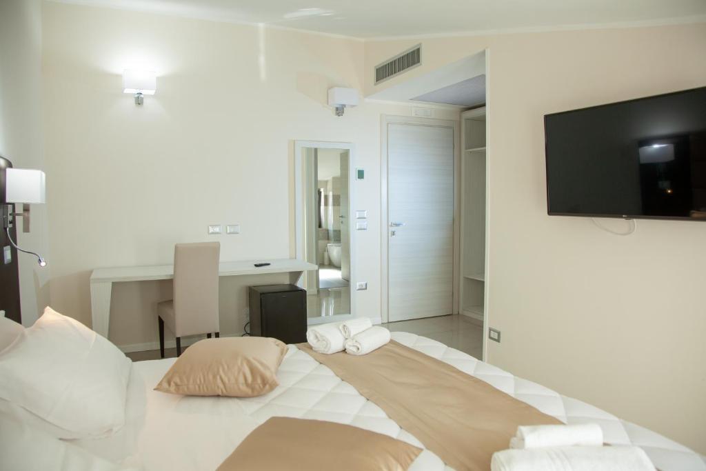 Postel nebo postele na pokoji v ubytování Hotel Dolce Stella