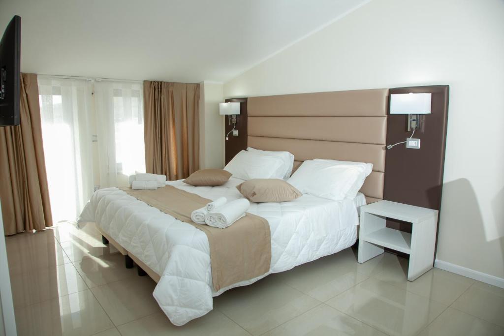 Postel nebo postele na pokoji v ubytování Hotel Dolce Stella