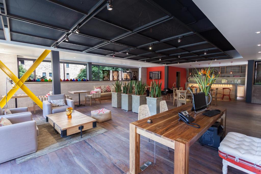 a living room with a table and chairs at Mika Suites in Bogotá