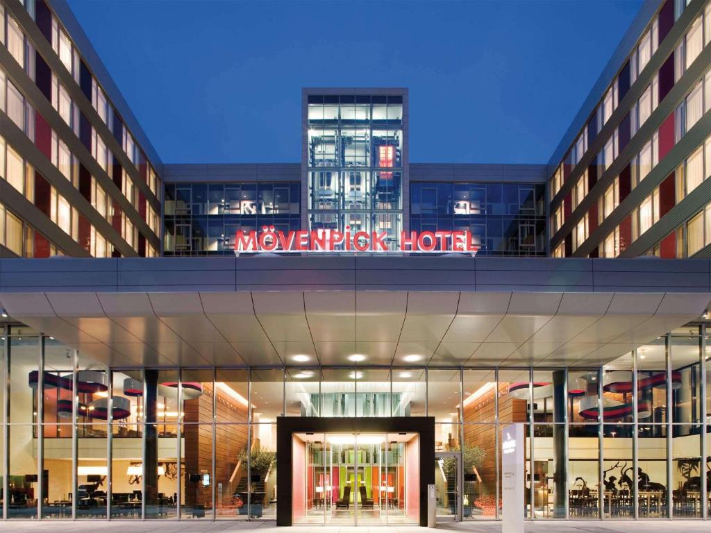 a building with a sign that reads synergy synergy hotel at Mövenpick Hotel Stuttgart Airport in Stuttgart