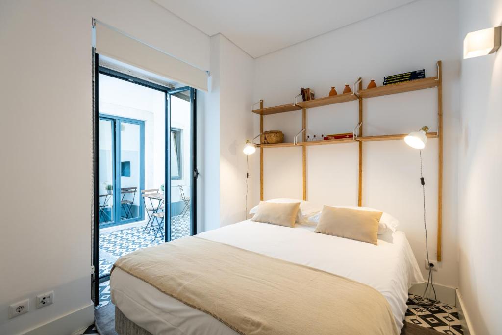 Uma cama ou camas num quarto em Villa Graça -Hostels and Apartments